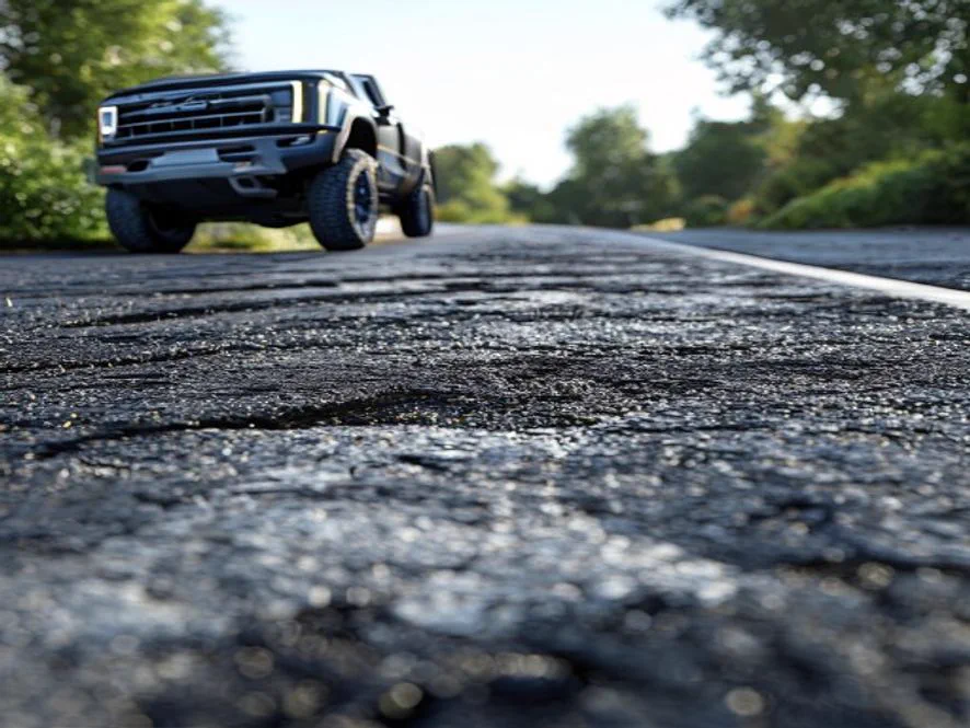 Cross section of a thick asphalt driveway showing the asphalt layer over a deep gravel base